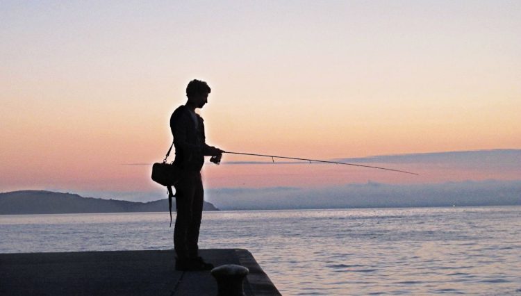 Fishing from the harbour wall at Mevagissey.